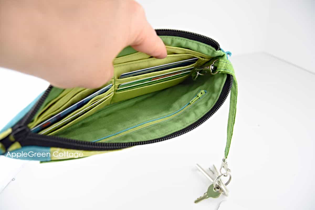 The finished green fabric detachable keyholder hooked onto the bag lining and keys hanging from it.