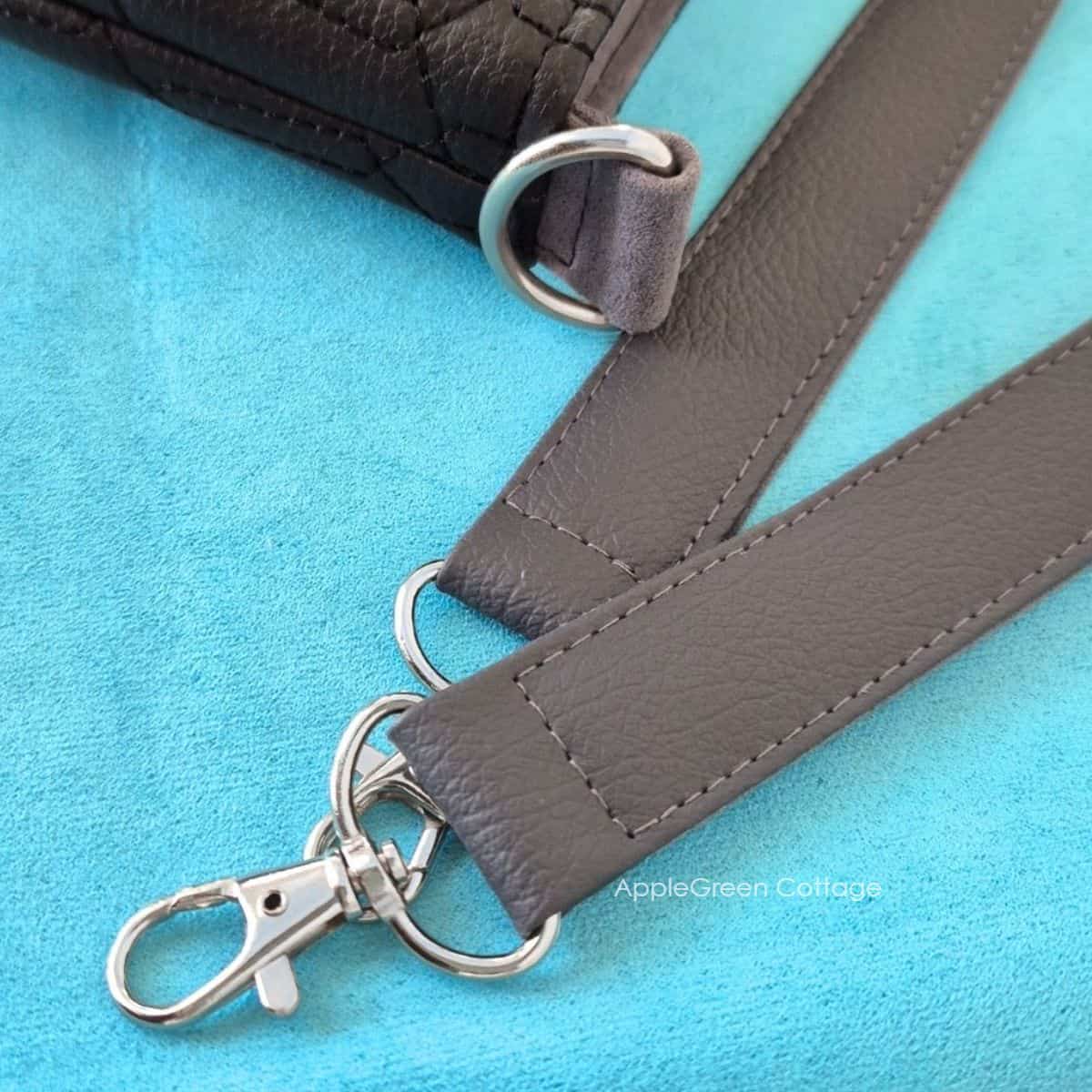 Faux leather bag strap end with swivel clasp and D-ring attachment
