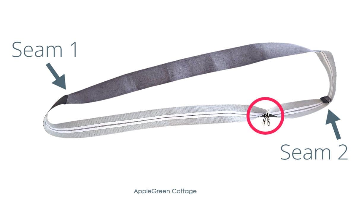 Long faux leather strap with swivel hooks on it.