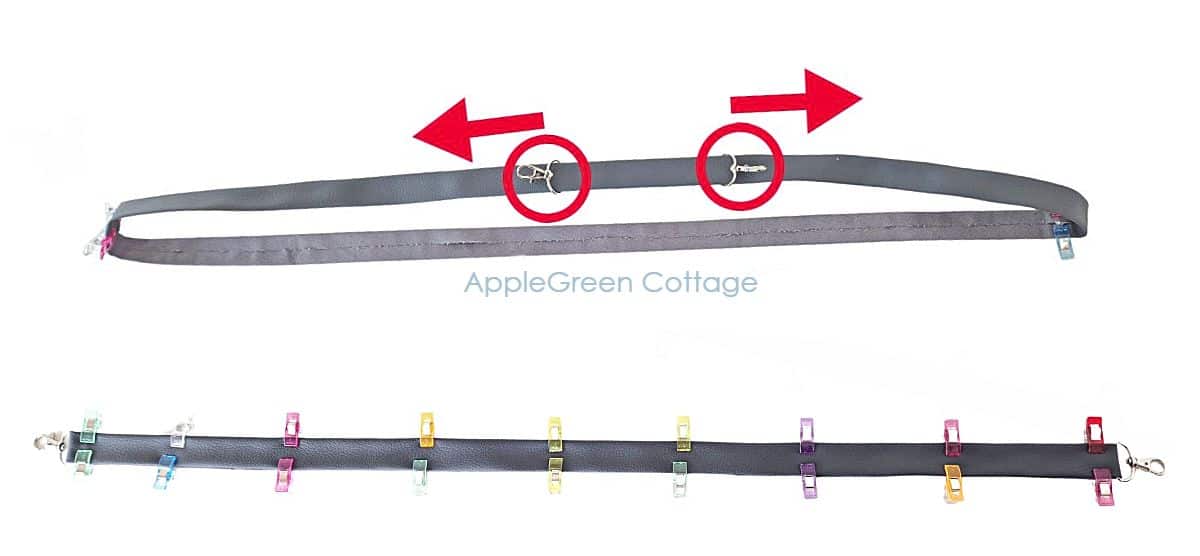 Long faux leather strap clipped with colorful sewing clips, ready for stitching.