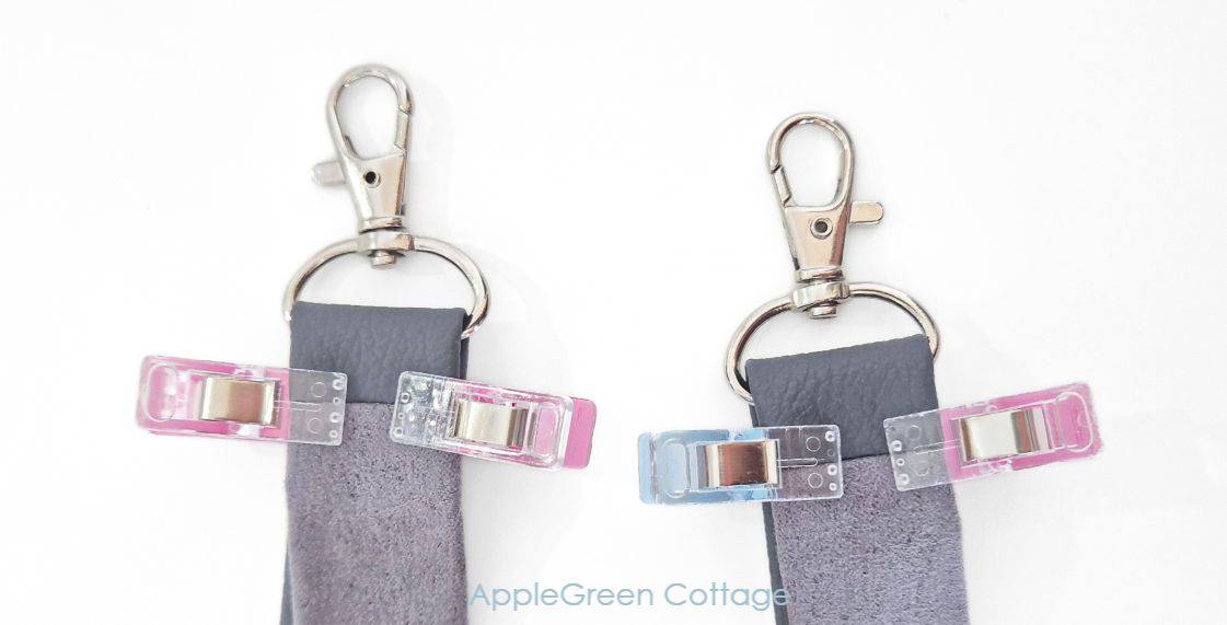 Strap ends clipped around swivel hooks with sewing clips before stitching.