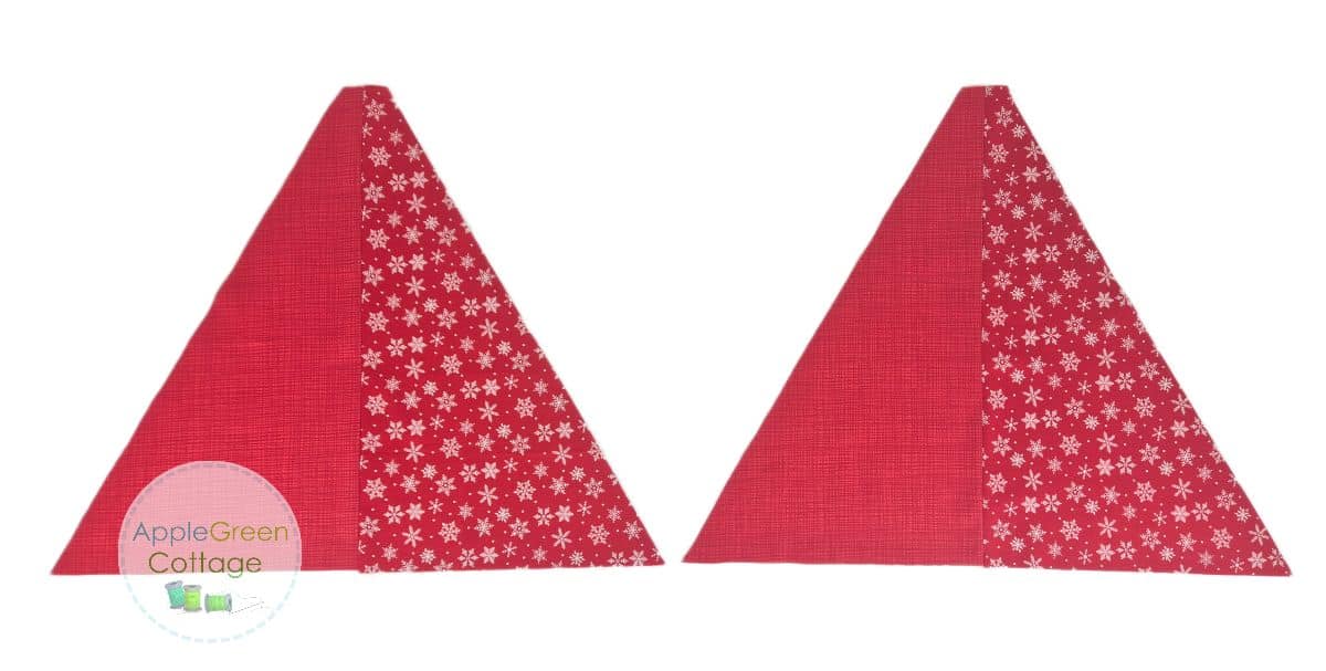 Two red triangle quilt blocks sewn with alternating snowflake and solid fabrics for tree skirt assembly.