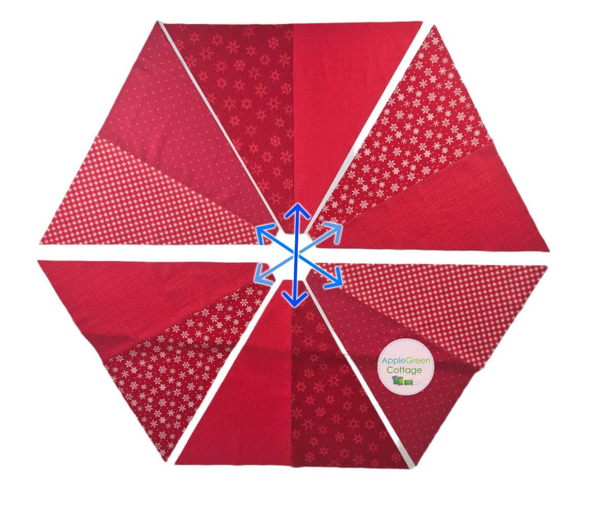Hexagon layout showing all six red triangle panels joined for tree skirt assembly.