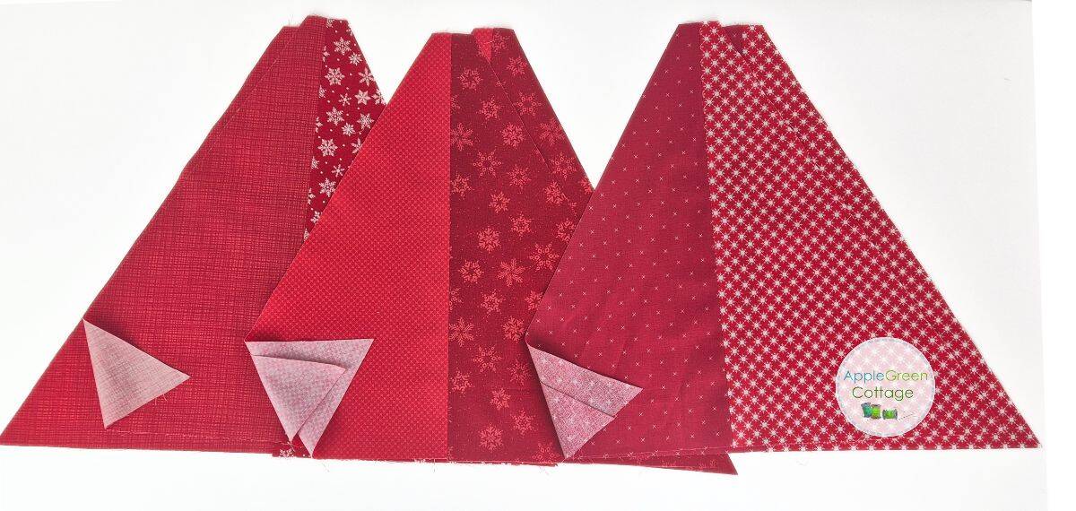 Six red triangle quilt sections showing layout and fabric placement for hexagonal tree skirt.