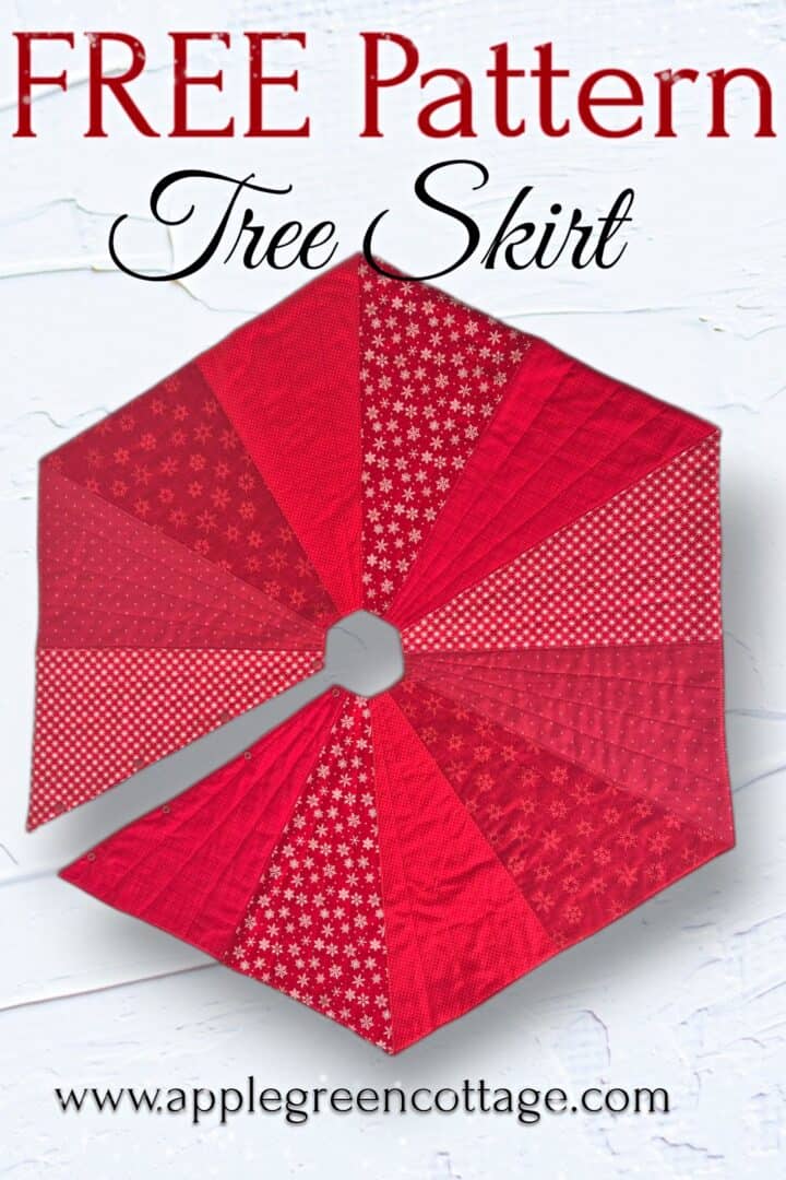 Finished red quilted hexagonal Christmas tree skirt made from six triangle panels.