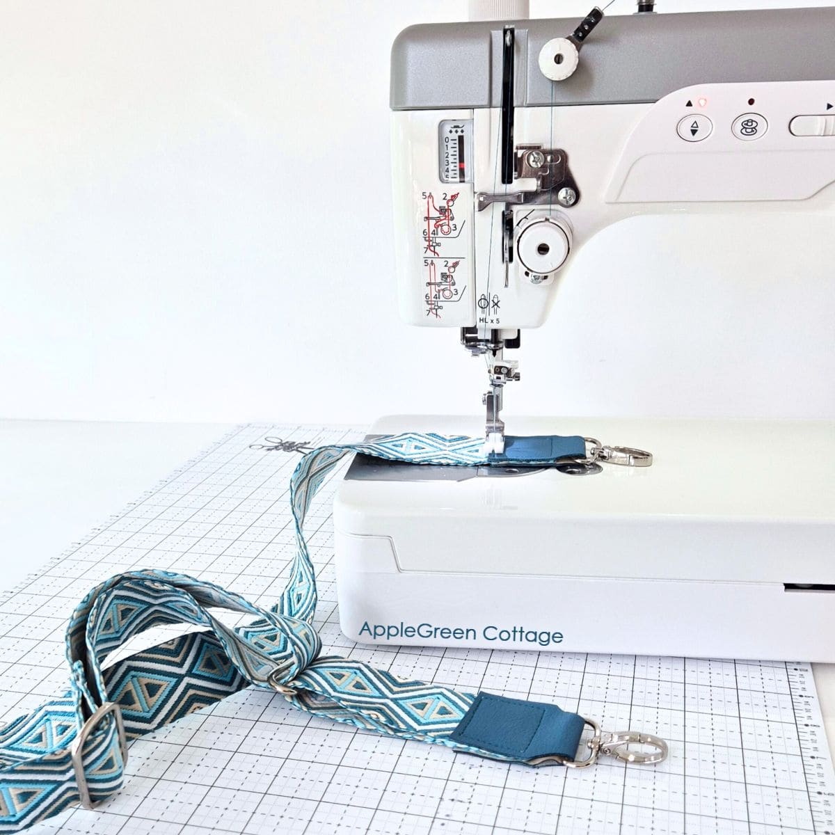 Bag strap with connectors being sewn on a Janome HD9 sewing machine.