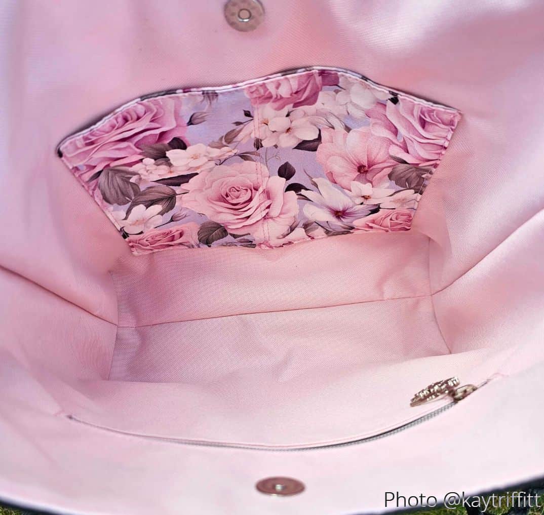Interior of floral-lined ISKA hobo bag showing slip pocket and zipper pocket on pink lining.