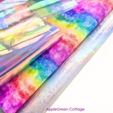Iridescent vinyl sheets layered with colorful fabric for a sewing vinyl tutorial.