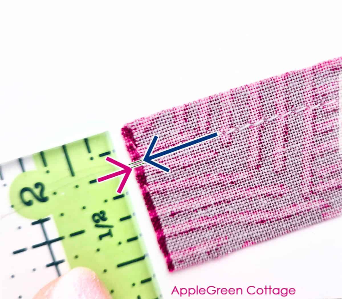 Measuring a scant quarter inch seam with quilting ruler to check seam allowance accuracy.