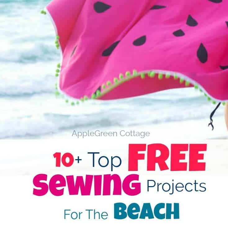 a handmade pink beach towel with pompom trim, placed on the sand close to the sea.