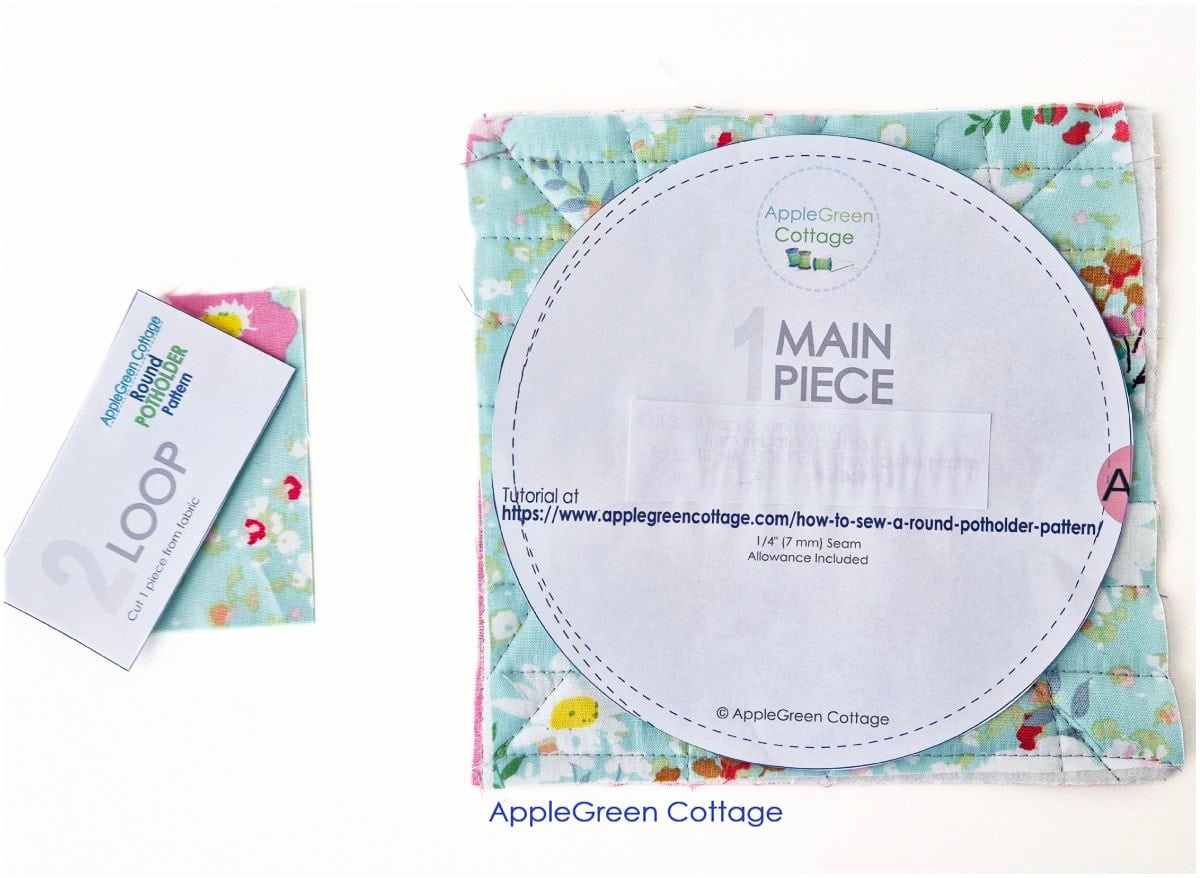 Floral fabric, batting and backing layered beside quilted potholder fabric sample.