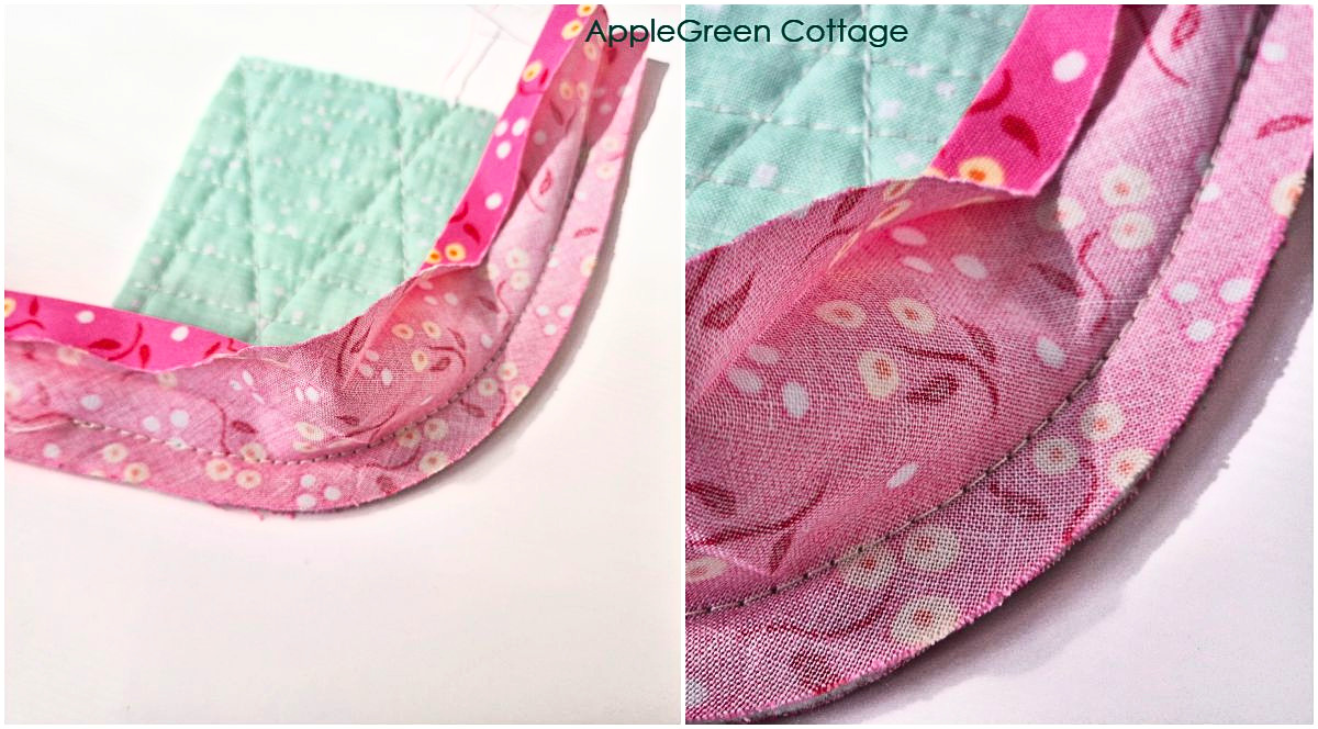 Bias tape sewn around curved quilt edge showing smooth fold and stitching detail.