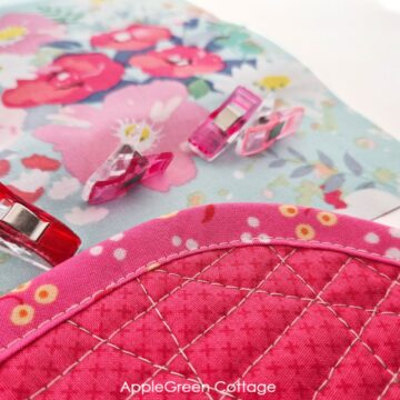 Finished quilt binding close-up with neat edge stitching and smooth curve.