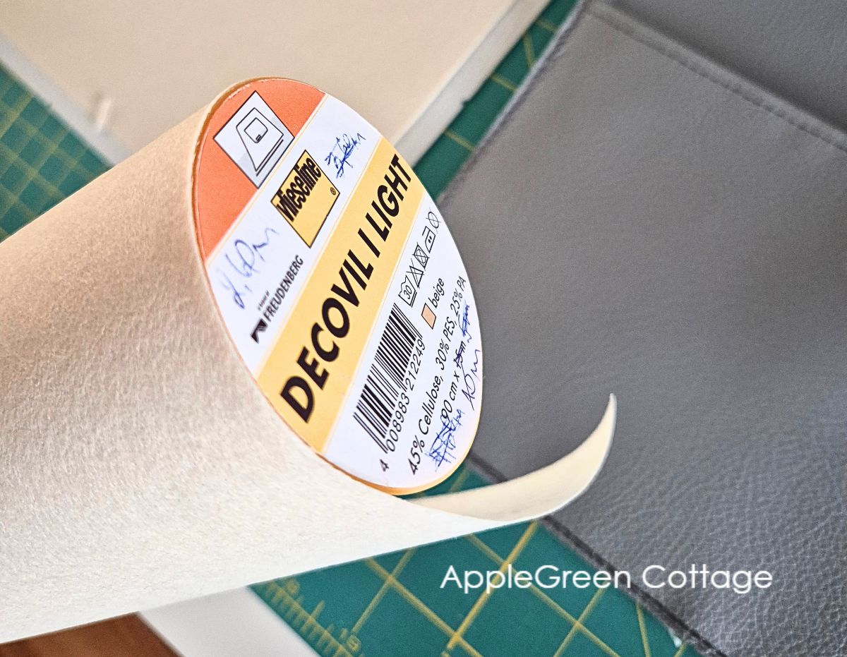 Decovil Light roll beside faux leather bag pieces on a cutting mat.