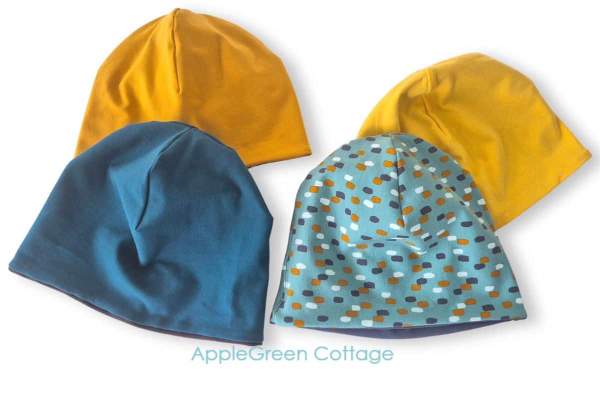 sewing pattern for baby hat Four handmade reversible beanie hats in solid and print fabrics, sewn using applegreencottage beanie sewing pattern.