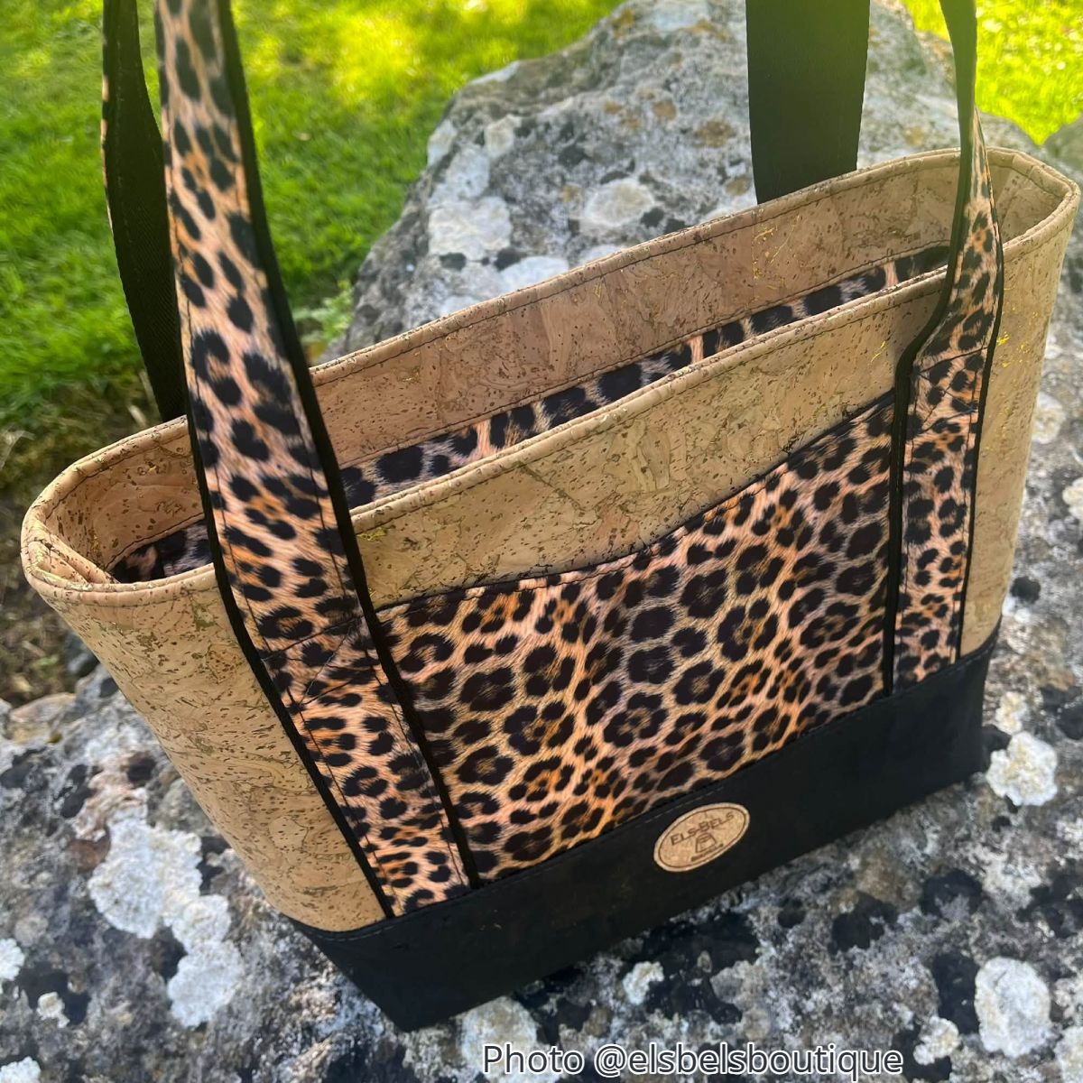 Leopard-print handmade tote with black handles and structured front pocket.