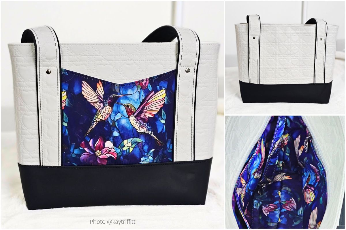 Black and white handmade tote with colorful hummingbird-print front pocket and striped handles.