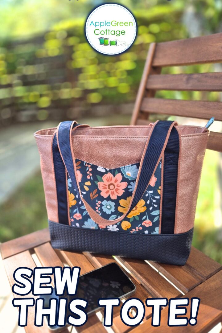 AVELA handmade tote bag with floral front pocket, two-tone handles, and structured base.